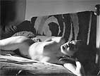 Meret Oppenheim nuded, laying on a sofa